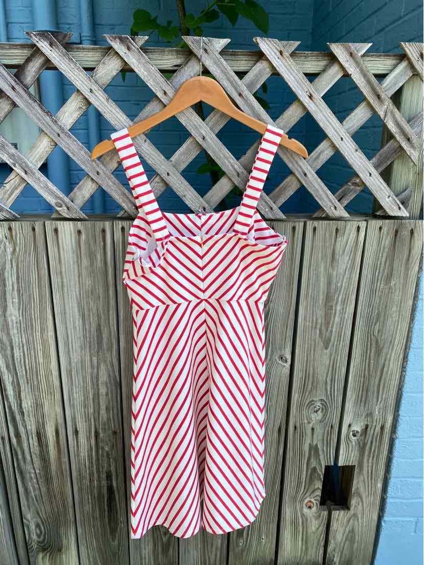 White and coral striped sleeveless dress with square neckline and fitted waist.