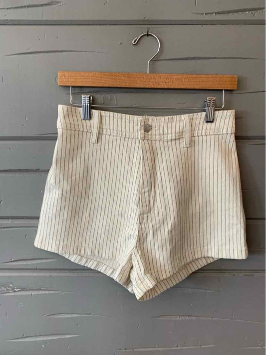 Beige and white vertical striped high-waisted shorts with front button and zipper closure.
