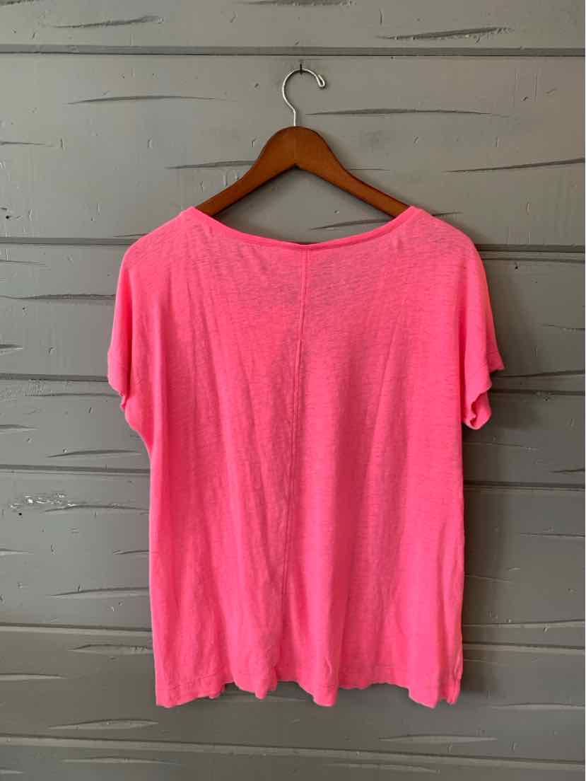 Bright pink short-sleeve blouse with a loose fit, soft fabric, and a round neckline.