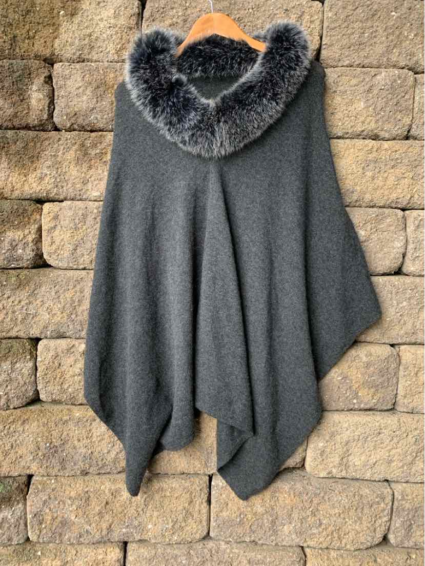 Gray cashmere wrap with a soft fur-trimmed hood, draped open front and cozy texture.