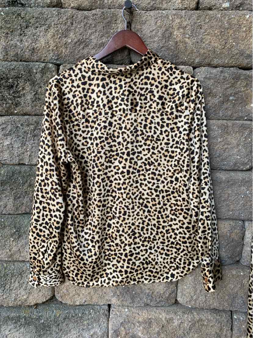 Long-sleeve button-up blouse in beige with black and brown cheetah print, gathered cuffs, and classic collar.