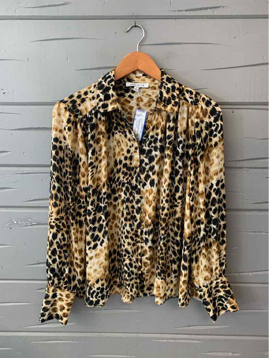 Tan and black cheetah print casual top with button-down front and long sleeves on wooden hanger.