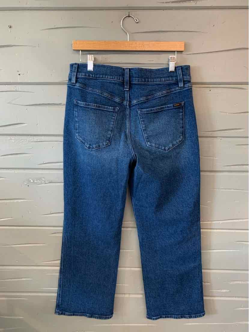 Blue denim jeans with back pockets and straight leg cut, size 12P, hanging on wooden hanger.
