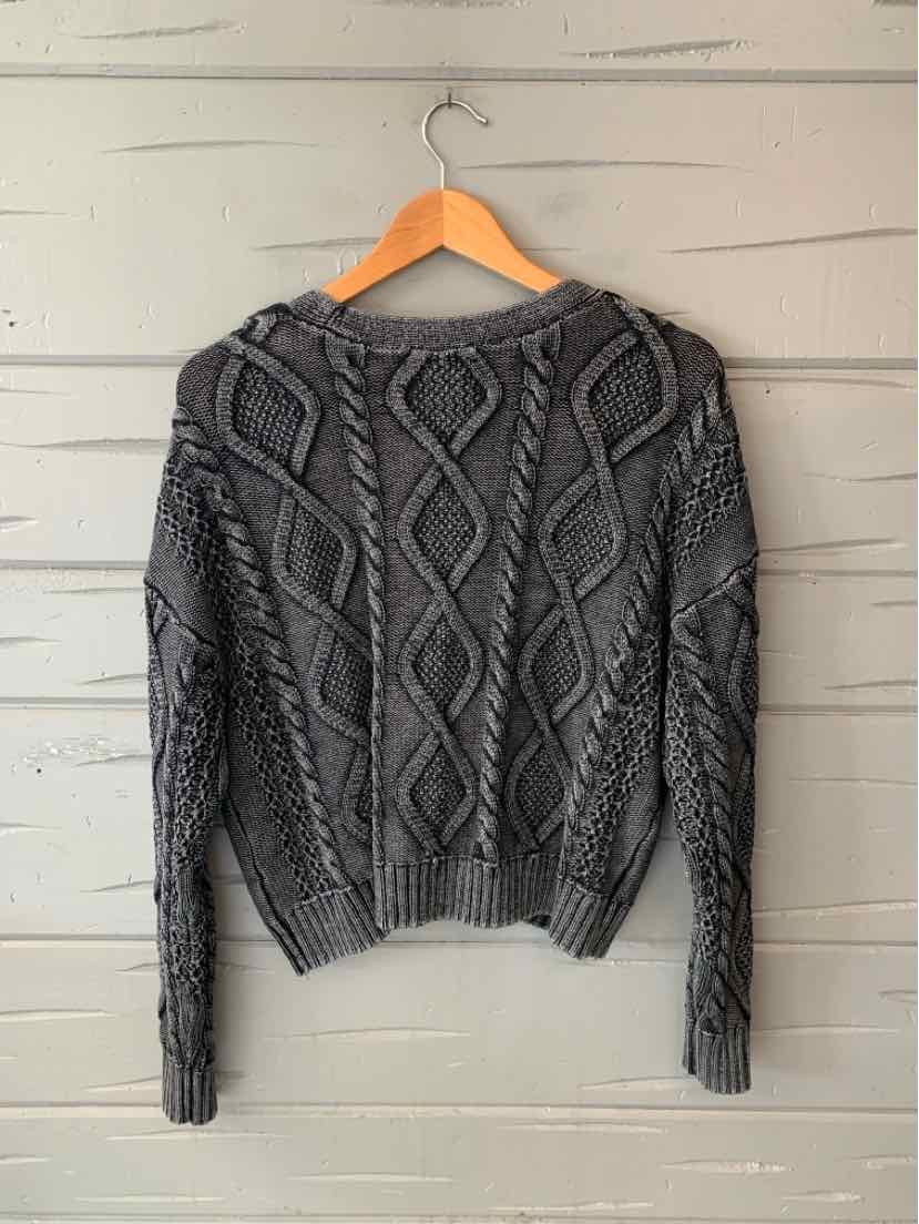 Women’s charcoal gray cable-knit sweater with a round neckline, long sleeves, and ribbed trim.