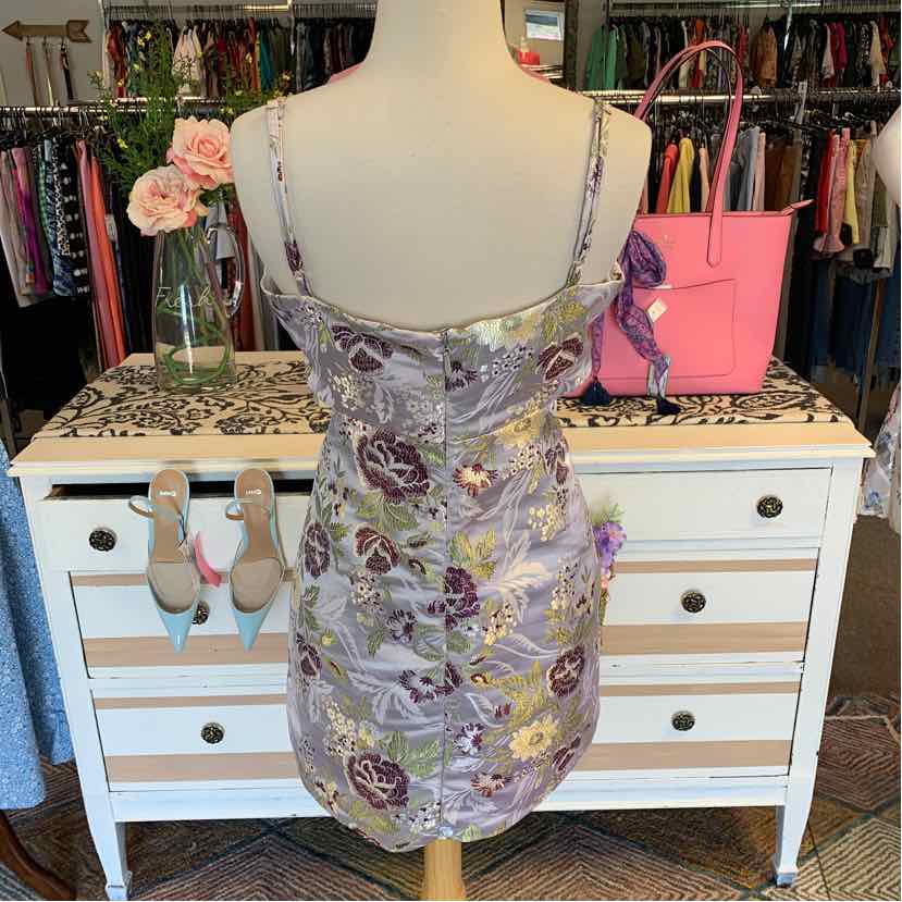 Floral print fitted mini dress with adjustable spaghetti straps and back zipper closure.