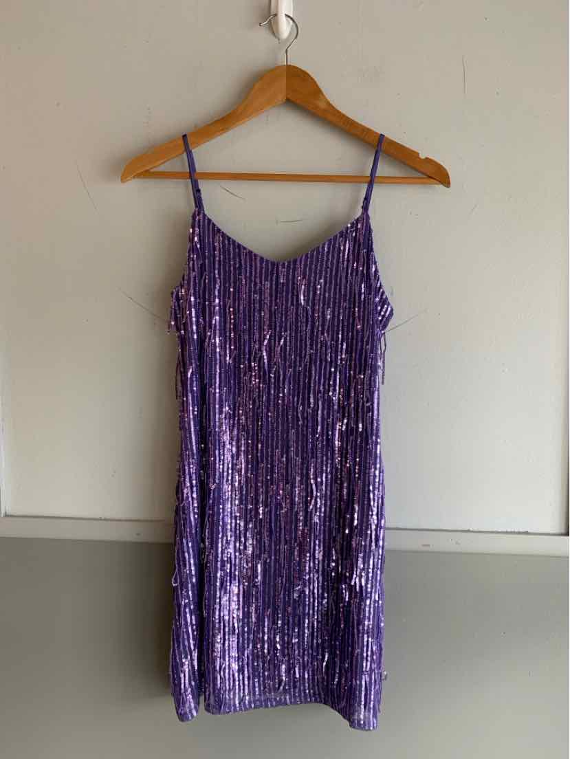 Purple sequined mini dress with thin spaghetti straps and a straight neckline.