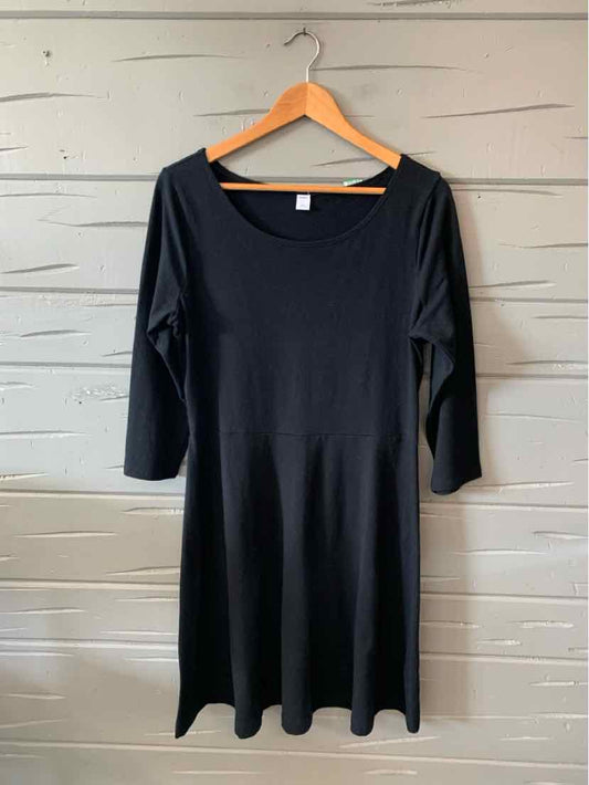 Black cotton blend dress with three-quarter sleeves and a scoop neckline, knee-length.