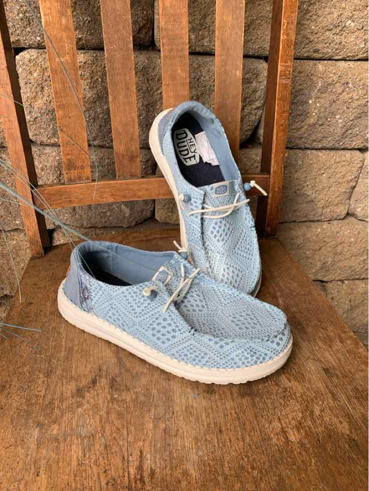 Light blue woven fabric casual shoes with white soles and beige laces, slip-on design.