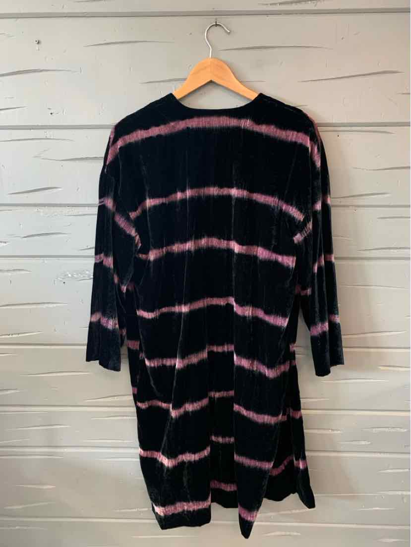 Long-sleeve black dress with horizontal pink tie-dye stripes, relaxed fit, hanging on wooden hanger.