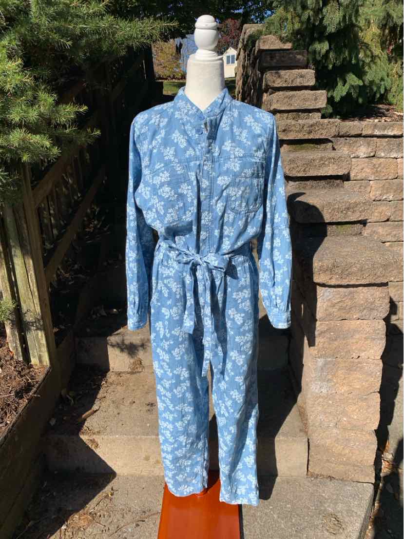 Blue floral Old Navy long-sleeve jumpsuit with a collared neckline, button front, and matching waist tie.