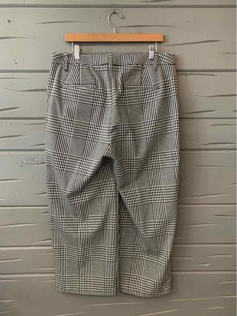 Gray plaid mid-length skirt with belt loops and side pockets hanging on wooden hanger.