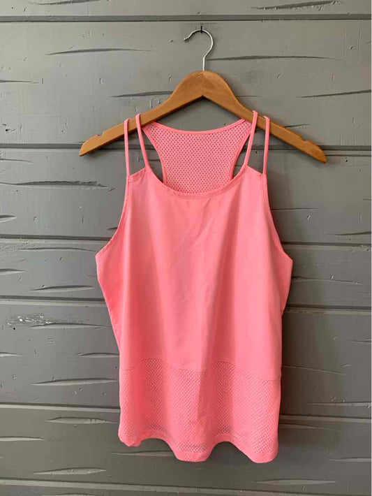 Pink sleeveless athletic tank top with double thin straps and scoop neckline, hanging on wooden hanger.