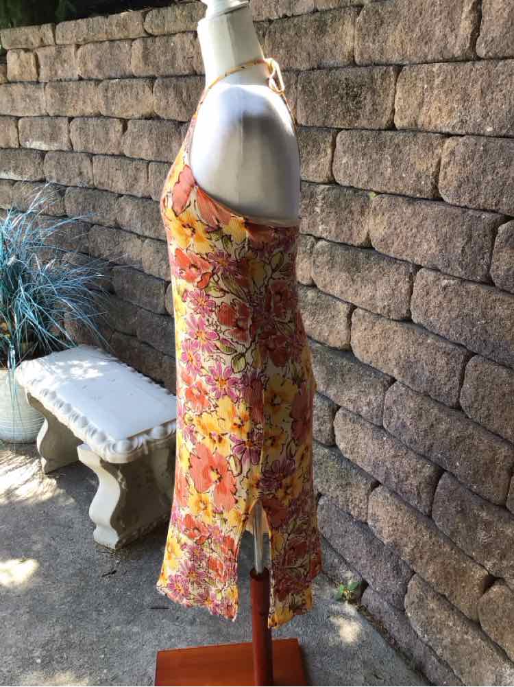 Sleeveless midi dress with orange and pink floral pattern, slim fit, side slit, lightweight fabric.