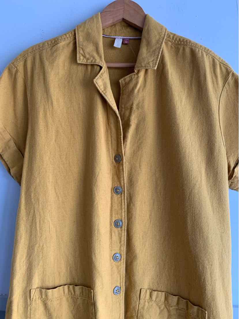 Mustard yellow short-sleeve button-up shirt with a relaxed collar and front pockets.