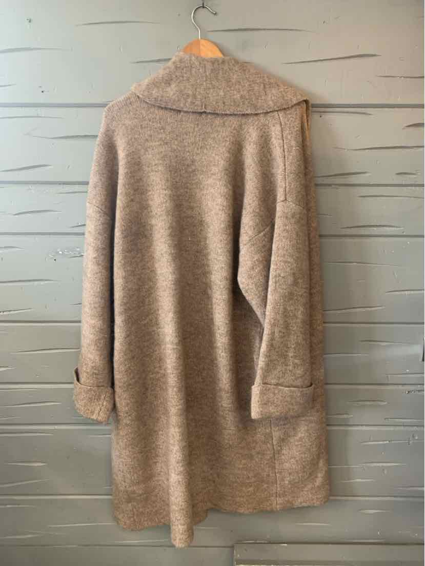 Beige oversized wool blend coat with wide collar and long sleeves in size XL hanging on wooden hanger.