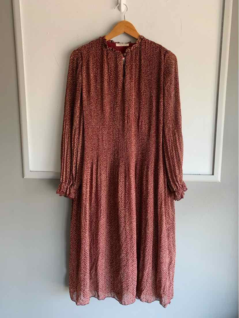 Burgundy midi dress with delicate floral print, long sleeves, gathered cuffs, and a round neckline with button details.