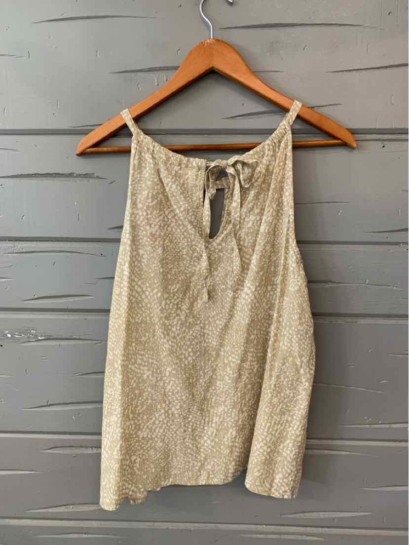 Tan sleeveless tank top with thin straps and subtle textured pattern hanging on wooden hanger.
