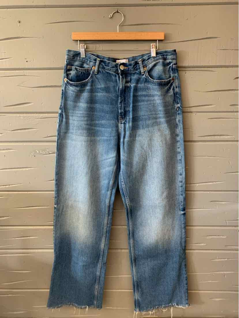 Light blue faded denim jeans with a relaxed fit, high waist, and raw hem detailing.