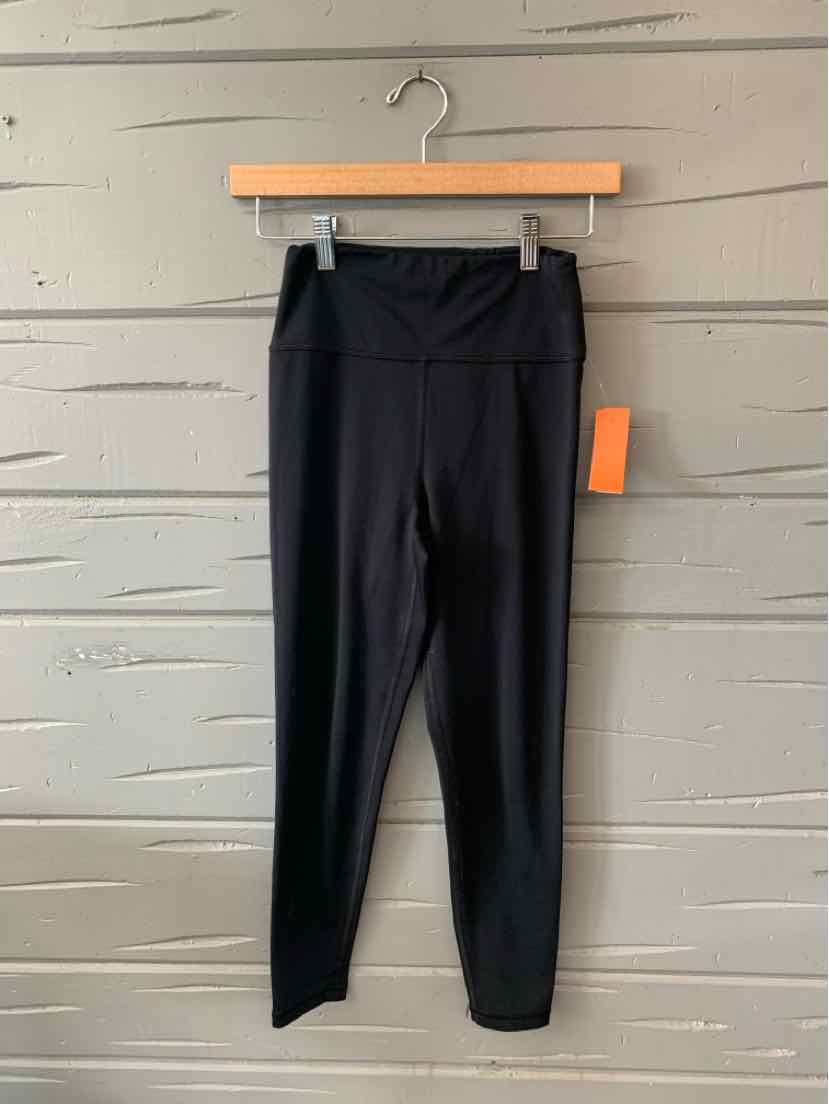 Black high-waisted solid leggings with a wide waistband, size small, hanging on a wooden hanger.