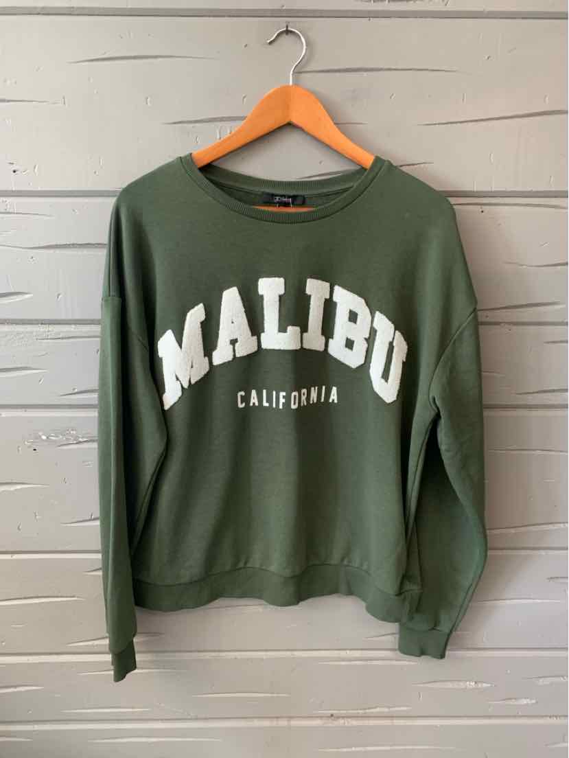 Green crewneck sweatshirt with "MALIBU CALIFORNIA" printed in white block letters across the front.