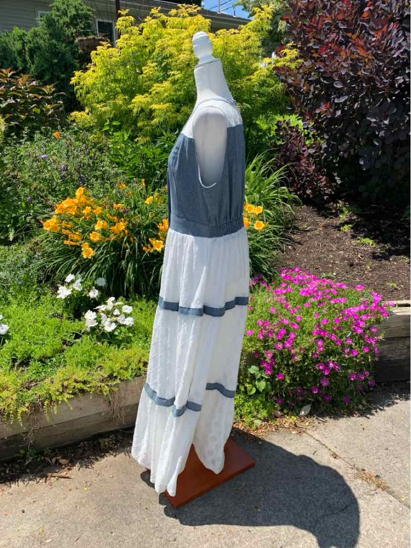 Sleeveless maxi dress with a blue fitted bodice and tiered white skirt featuring blue ruffle details.