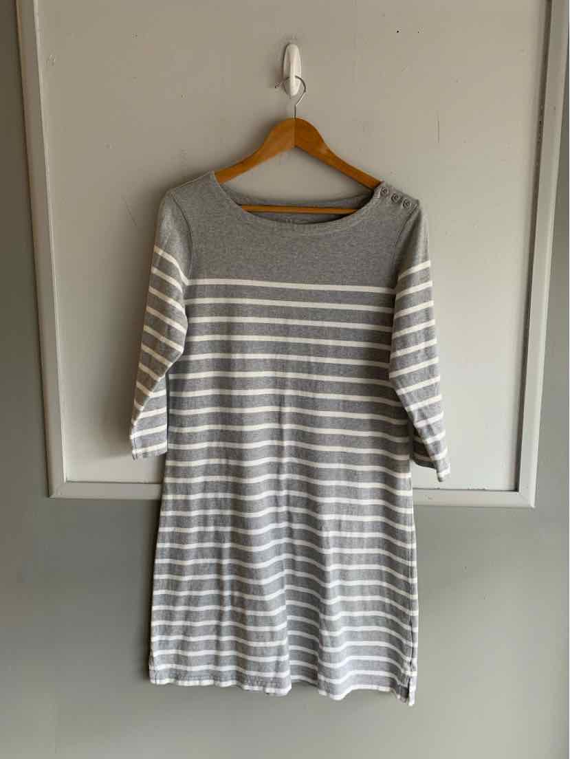 Gray and white striped long-sleeve casual dress with boat neckline hanging on wooden hanger.