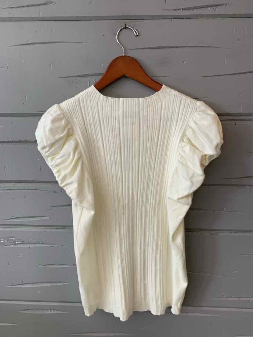 Cream ribbed knit top with short puff sleeves and round neckline on wooden hanger.