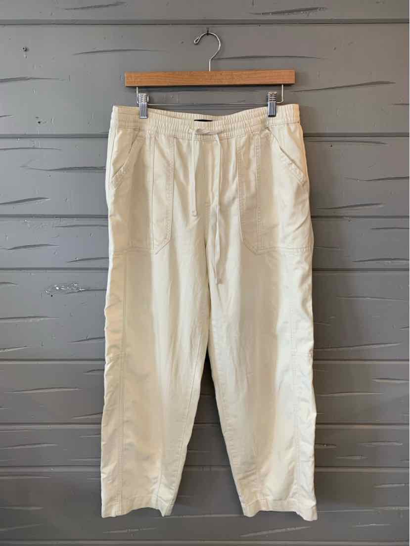 Light beige straight-leg pants with belt loops and front pockets hanging on wooden hanger.