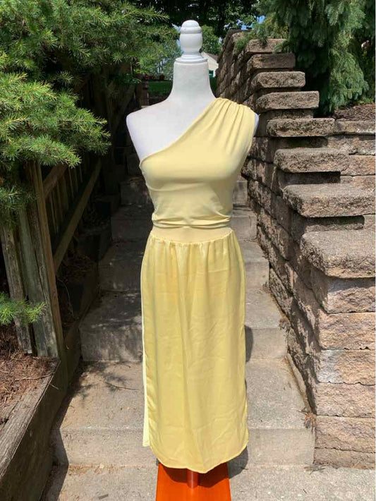 Yellow one-shoulder midi dress with gathered waist and smooth fabric.