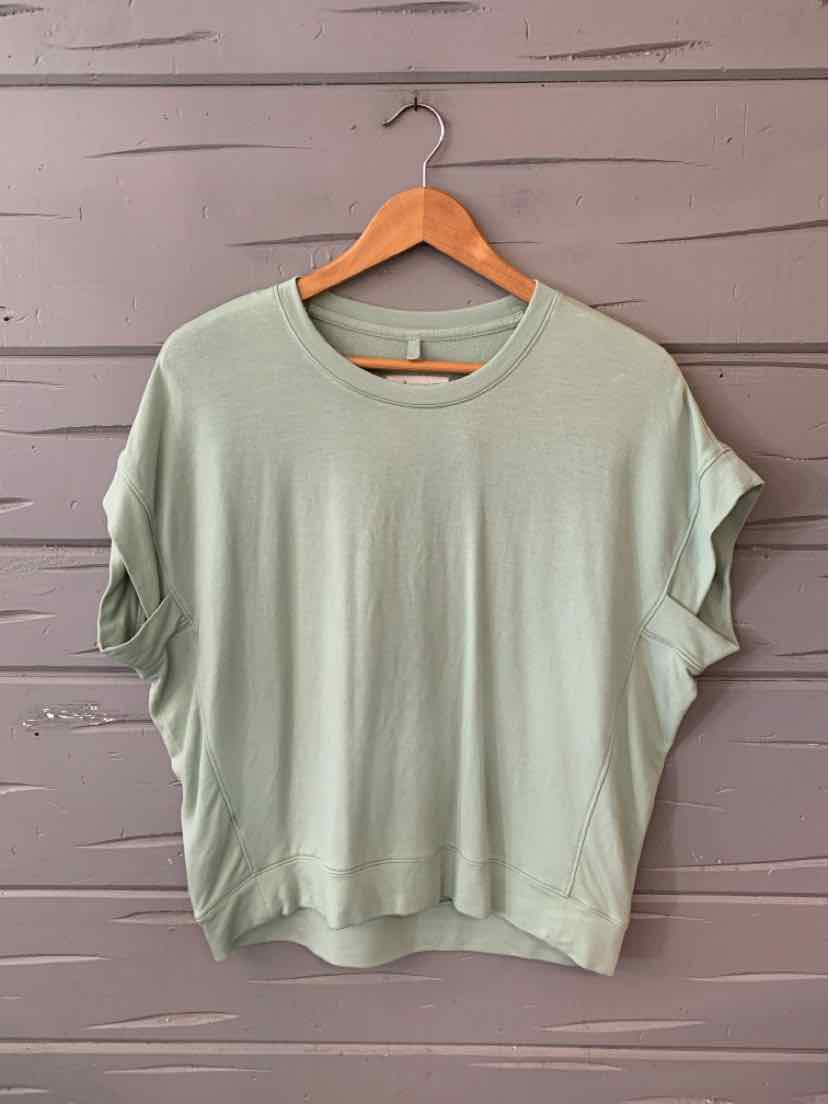 Light sage green short-sleeve relaxed fit t-shirt with round neckline and rolled sleeve detail.