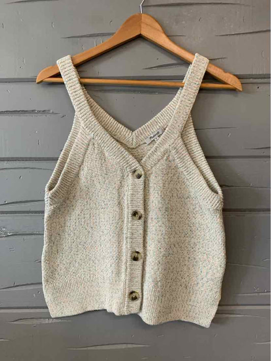 Cream knit sleeveless button-up cardigan with wide straps on wooden hanger.