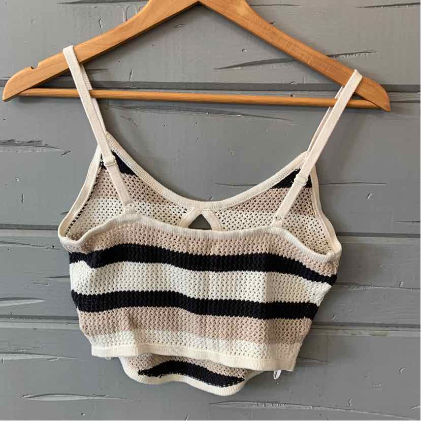 Knitted crop top with beige, black, and white horizontal stripes and thin adjustable straps.