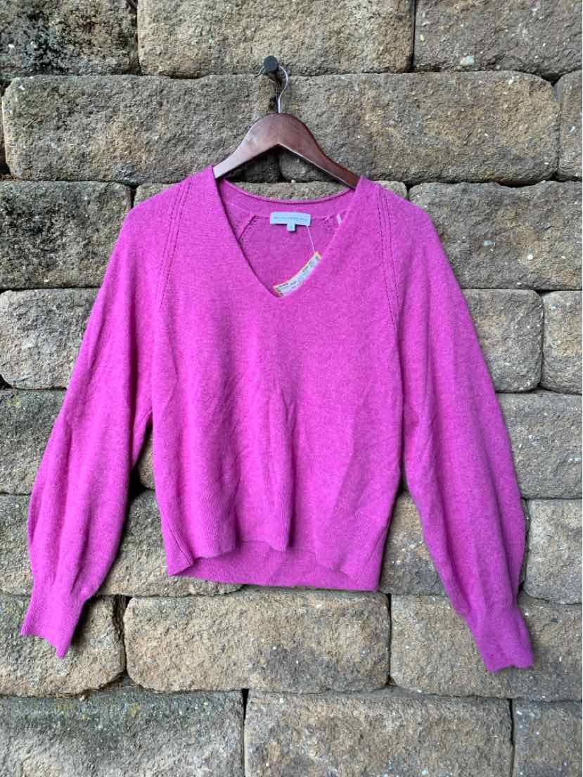 Soft pink wool V-neck sweater with long sleeves and ribbed cuffs and hem.