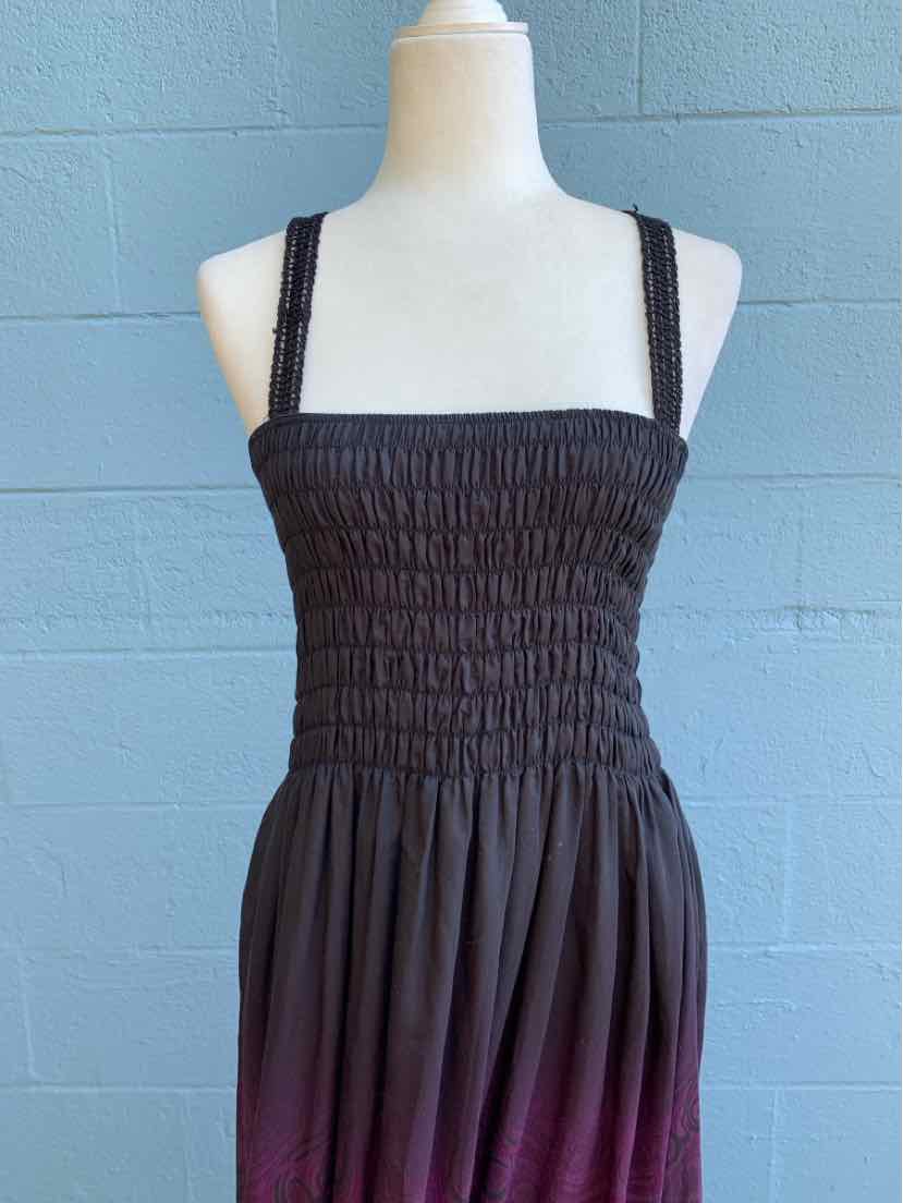 Black smocked bodice dress with square neckline and lace-trimmed shoulder straps.