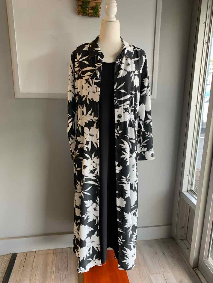 Black and white floral long open-front cardigan over a solid black dress on a mannequin.