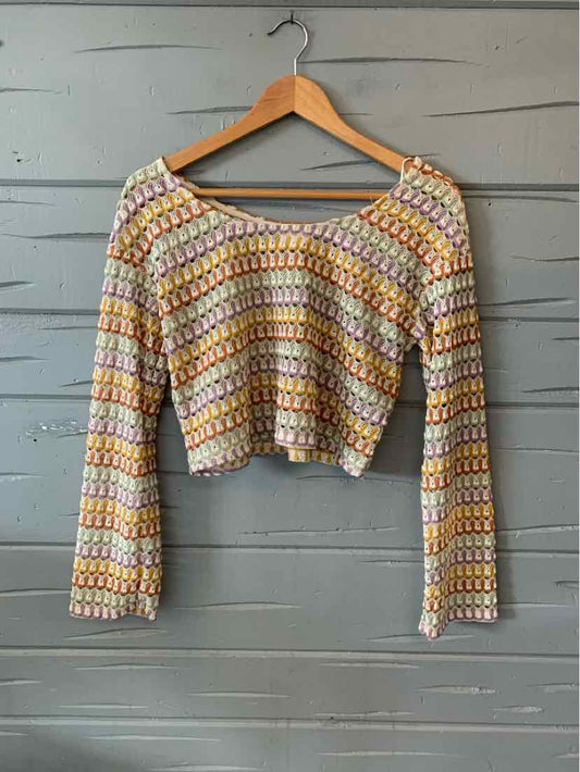 Multi-colored crochet long-sleeve crop top with scoop neckline and scalloped edges.