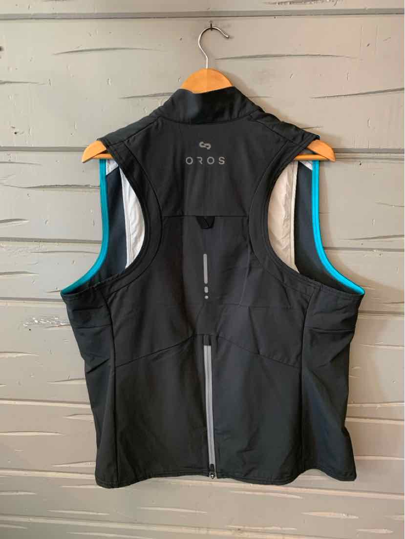 Black sleeveless performance vest with high collar and reflective vertical strip on back.