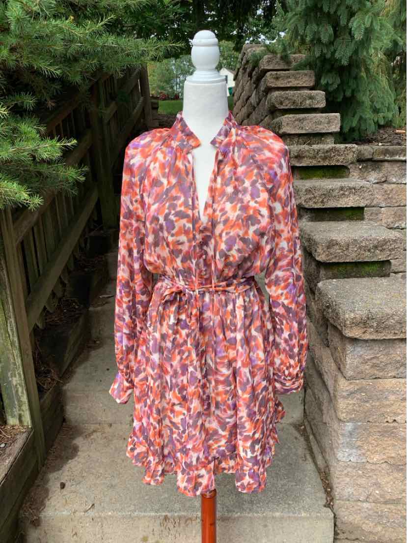 Long-sleeve floral dress in shades of orange, pink, and white with a cinched waist and flowy skirt.