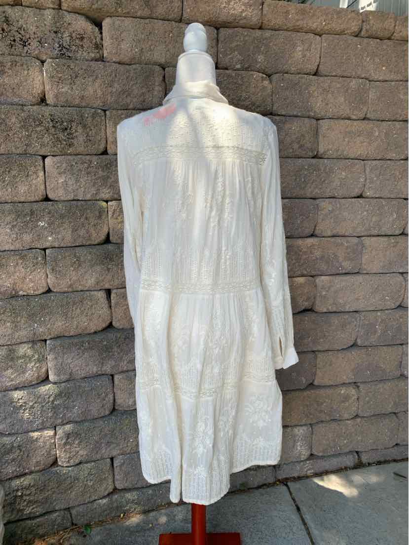 White long-sleeve midi dress with subtle textured pattern and loose fit.