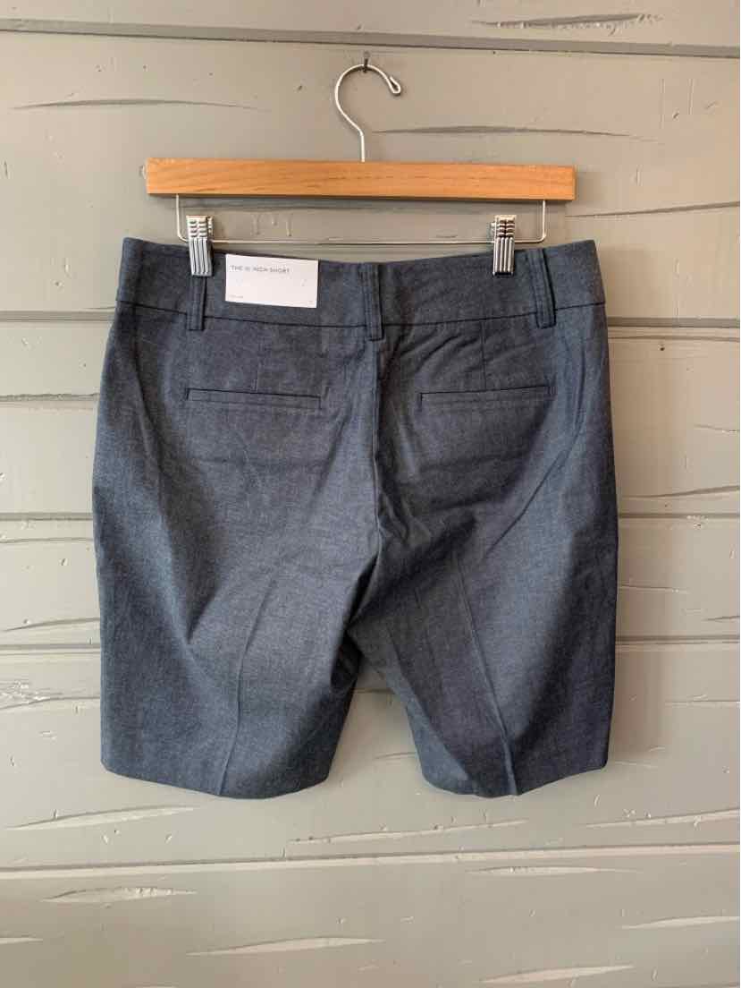 Charcoal gray tailored shorts with back welt pockets and belt loops, size 4.