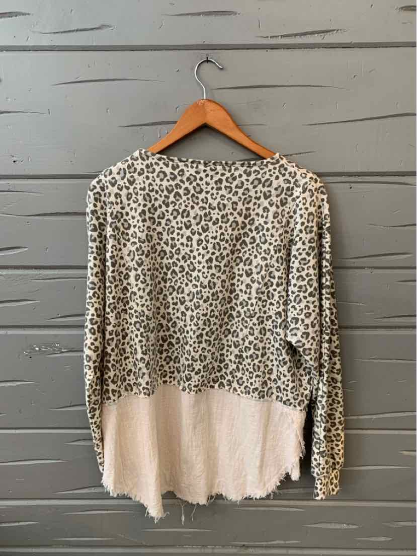 Long-sleeve leopard print top with a beige color block hem in small size hanging on wooden hanger.