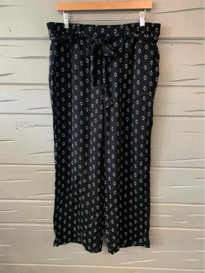 Black wide-leg pants with white geometric pattern and elastic paperbag waist with tie belt.