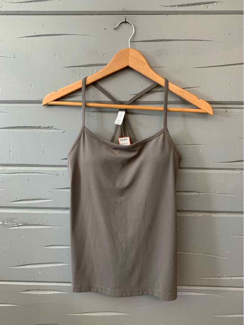 Solid brown spaghetti strap tank top with a crisscross back design hanging on a wooden hanger.