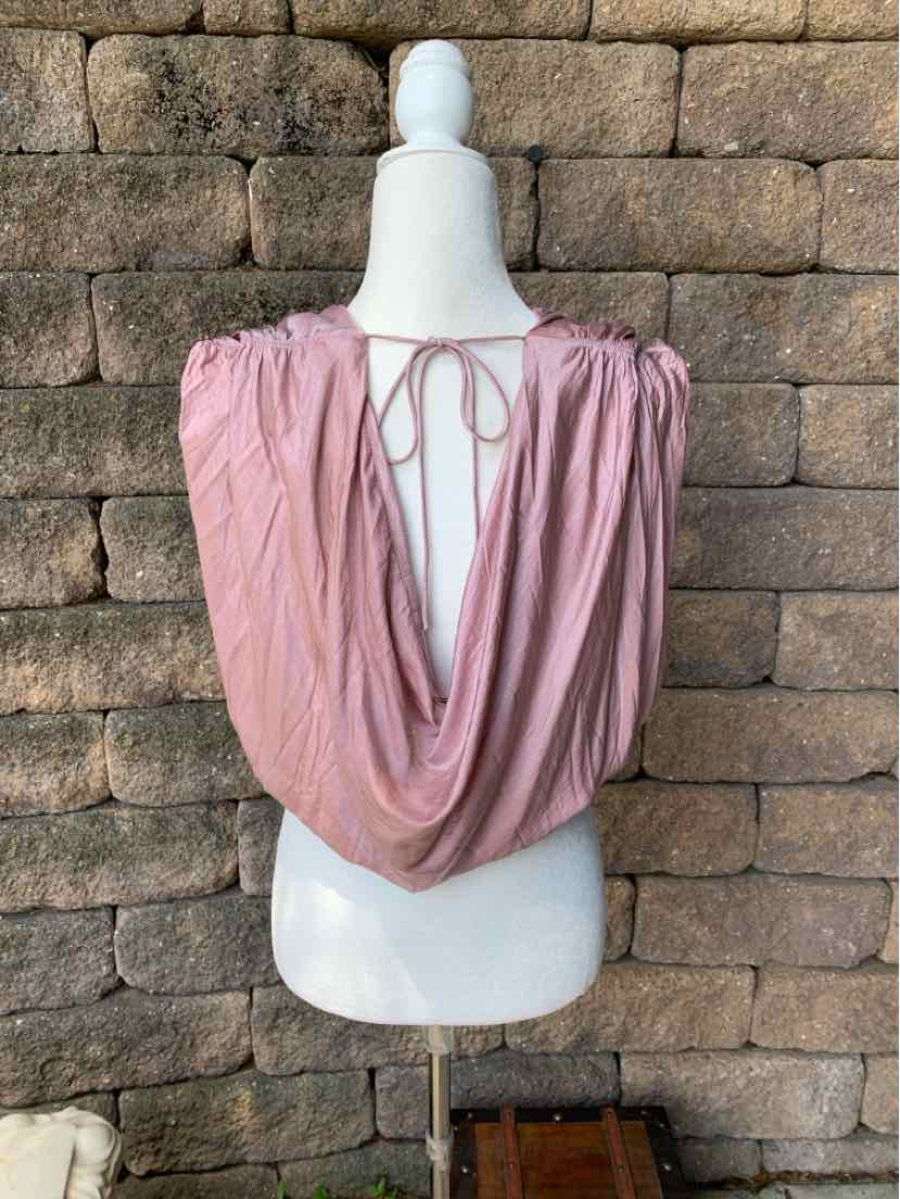 Light pink draped sleeveless top with open back and tie detail, soft flowy fabric.