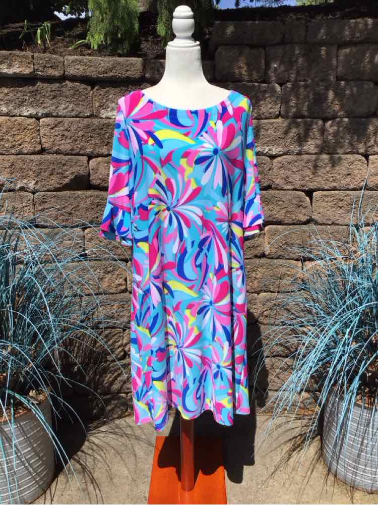 Colorful knee-length dress with abstract floral pattern in blue, pink, purple, and green, featuring 3/4 sleeves and a scoop.