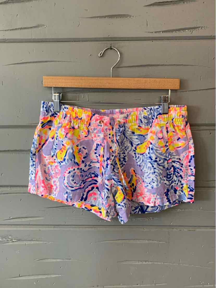 Colorful printed women's shorts with pink, yellow, and blue floral and abstract patterns on lightweight fabric.