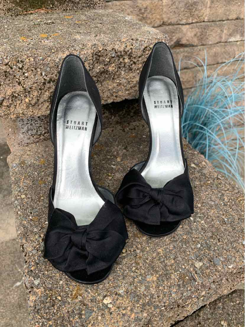 Black Stuart Weitzman women's size 7.5 flats with bow detail and silver insoles.