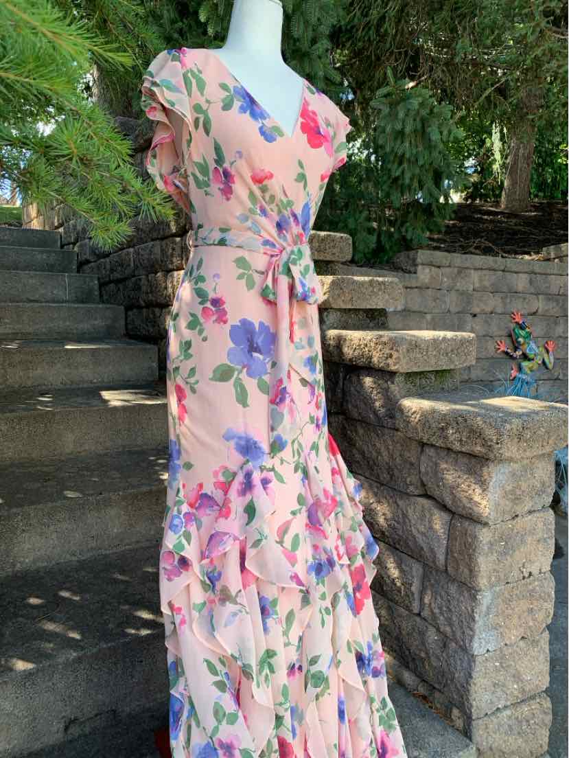 Light pink floral wrap dress with ruffled hem and short sleeves, tied waist, size 10.