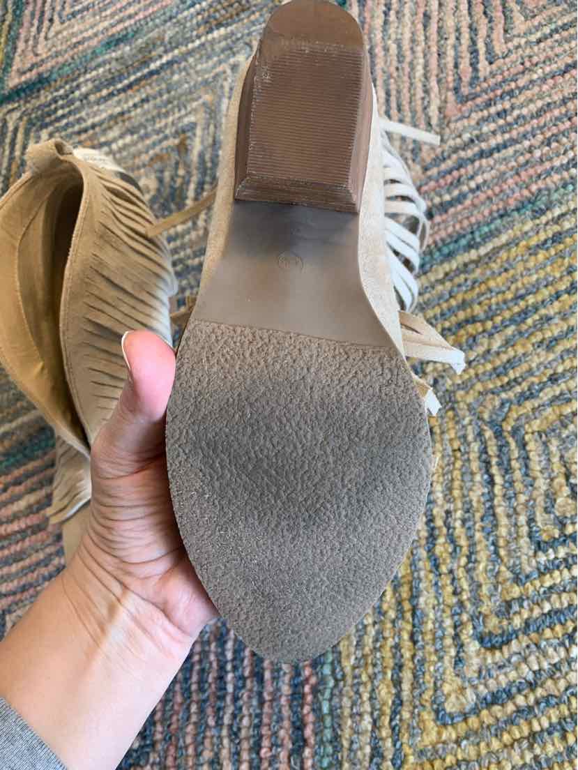 Beige suede boot with fringe detail and textured rubber sole, size 8.5.