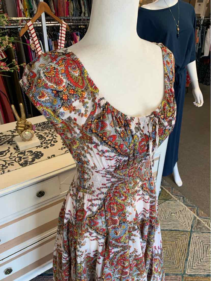 Sleeveless midi dress with multicolor paisley print, sweetheart neckline, and ruched bust detail.